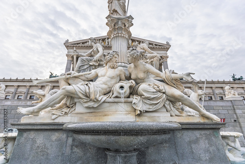 Schilderij op canvas Detail of allegorical marble sculptures at the Pallas Athene fountain in front o