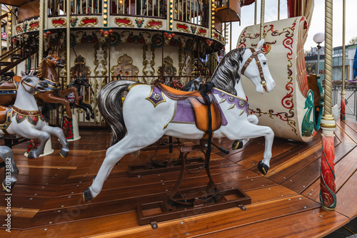 Foto Vintage carousel with ornate white horses at an amusement park