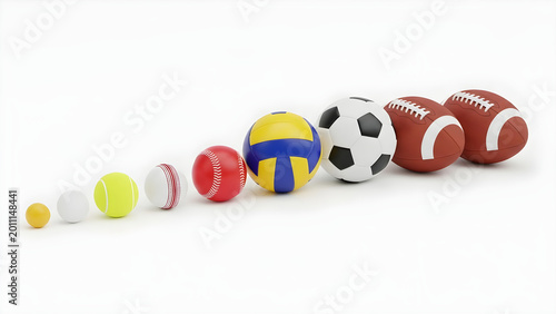 Various sports balls are arranged in a line on the floor indoors.