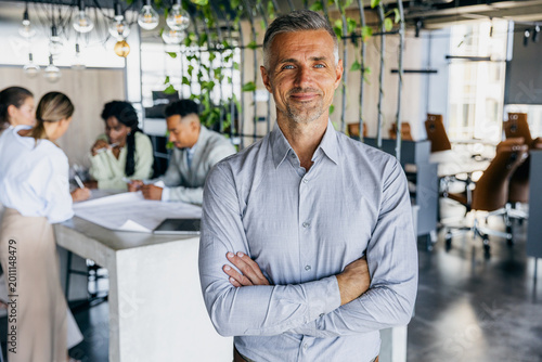 Selfassured male manager fostering teamwork in vibrant setting