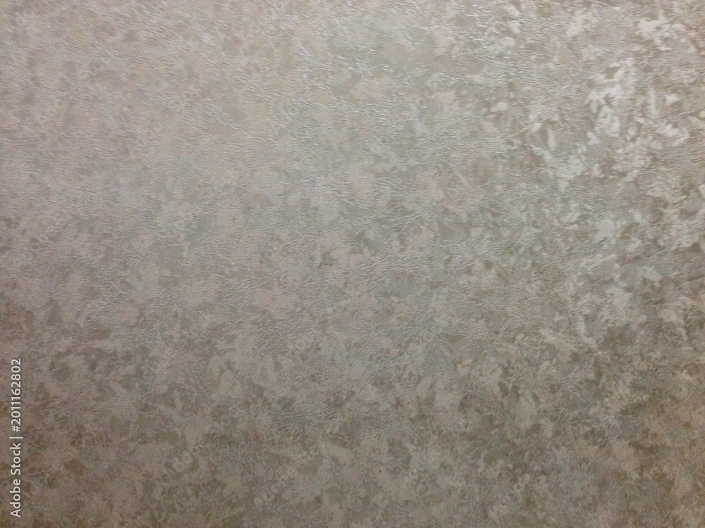 Fototapeta premium A metallic surface with irregular patterns and shiny reflective textures.