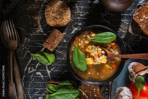Macro close-up of a rustic country style meal with vegetable soup and soft focus