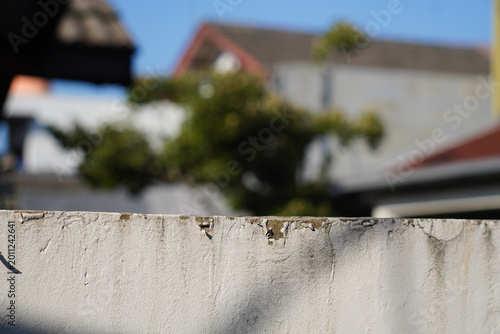 Weathered concrete wall with blurry background.