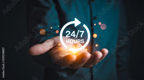24 hours customer support concept with glowing digital service icon and businessman holding virtual assistance symbol
