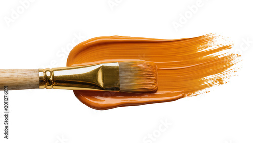 Photos Wooden paintbrush with golden ferrule creating an orange paint stroke, isolated