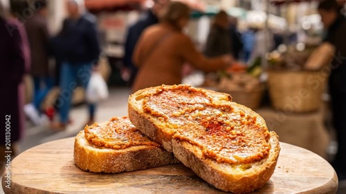 Toasted Crusty Bread with Canarian Almogrote Spread Served at a Traditional Outdoor Market.