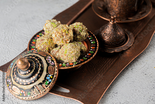 Desserts on a decorative tray and bowl in a kitchen setting