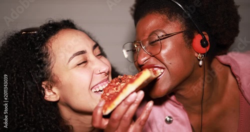 Hungry african american girls eating pizza outdoor in the streets after party concert - Food, people lifestyle and nightlife concept