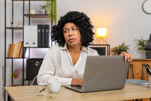 Photos African American businesswoman at home office frowns at laptop upset by game defeat fail, rejection email