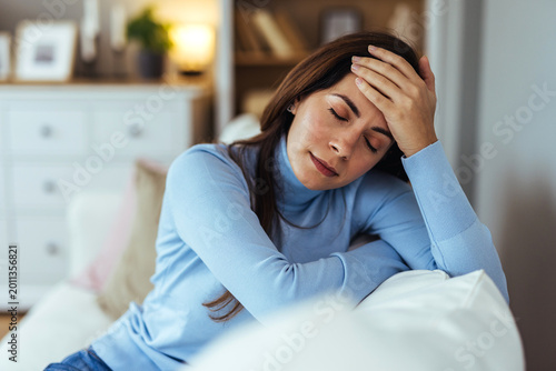 Fotografía Tired Young Woman With Headache Resting on Couch at Home, Stress and Fatigue Rel