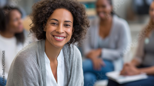Close-up of a therapist leaning forward with a comforting smile during an open group therapy session, compassionate care concept, mental health professional empathy, counseling