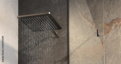 Square shower head in modern stone wet zone, static interior video captures the moment water begins to fall from the sleek fixture across dark and light surfaces in a premium bathroom setting