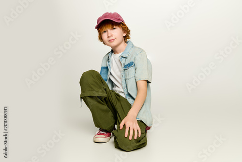 Slika na platnu Stylish little boy showcasing vibrant fashion in playful pose
