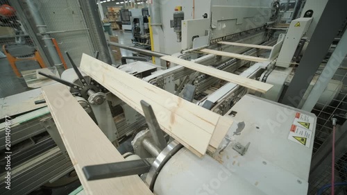 Close-up of an automated production line with timber slats in motion within a modern wood processing facility
