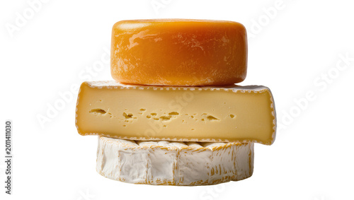 Obraz na plátně Stack of three cheese wheels a round Gouda a wedge of Gruyere and a Brie, isolat