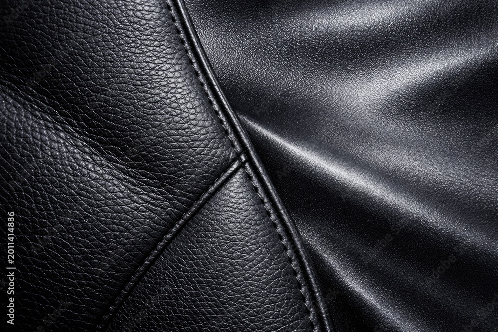 Fototapeta premium Textured black eco leather alongside dark grey synthetic material with reflective qualities