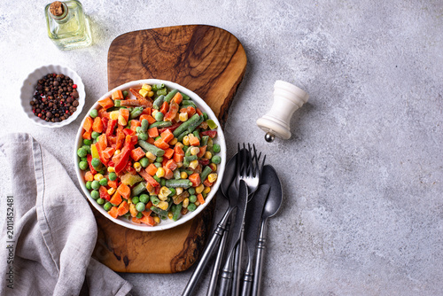 Frozen mix of vegetables on dark background