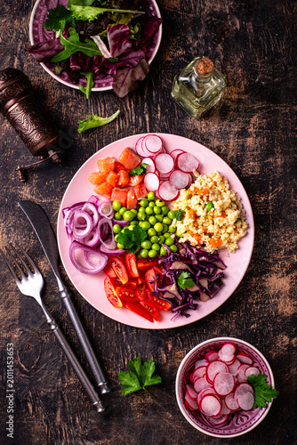 Balanced healthy bowl with vegetables and salmon