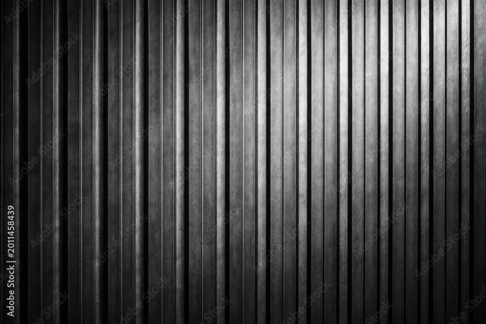 Obraz premium Rough vertical ribbed metallic texture under studio lighting for wall background copy space