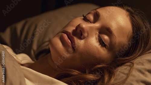 Close Up of Young Woman with Oily Face Sleeping Peacefully in Dark Room with Warm Light
