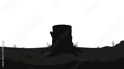 Foto Silhouette of a lone tree stump in a desolate landscape.