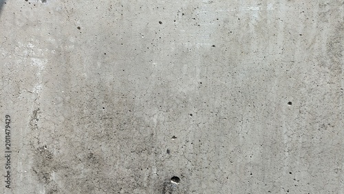 Gray concrete wall texture, weathered rough cement surface with small holes and cracks background