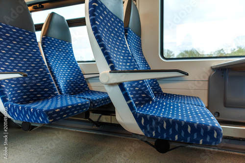 Obraz na plátně Interior of a deutsche bahn regional train carriage with empty blue seats and a table by the window