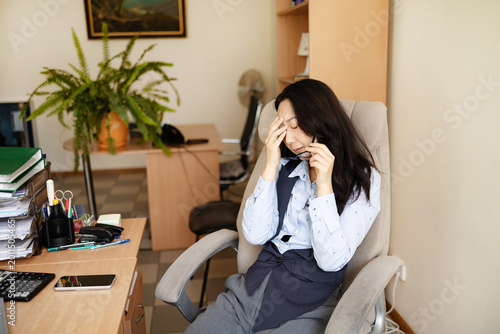 фотографія Drained restless woman going into mental haze with after hours tasks, rubbing eyes and struggling to stay awake