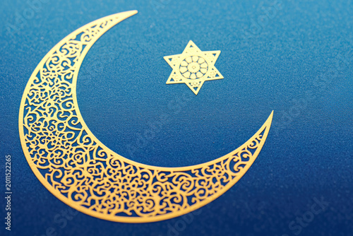 Elegant Golden Crescent Moon and Star Design on Blue Background, Celebrating Eid Mubarak Festive Concept