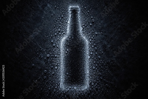 Bottle silhouette created by ice droplets against a dark textured background