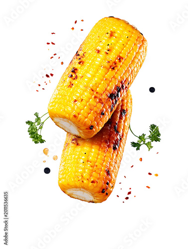 Two pieces of roasted sweet corn on the cob with charred marks isolated on white background.