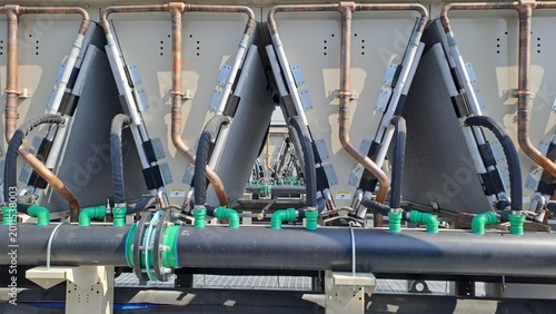 Close-up of Data Center Cooling System with Dry Cooler Coils, Copper Pipes and Industrial Piping Network