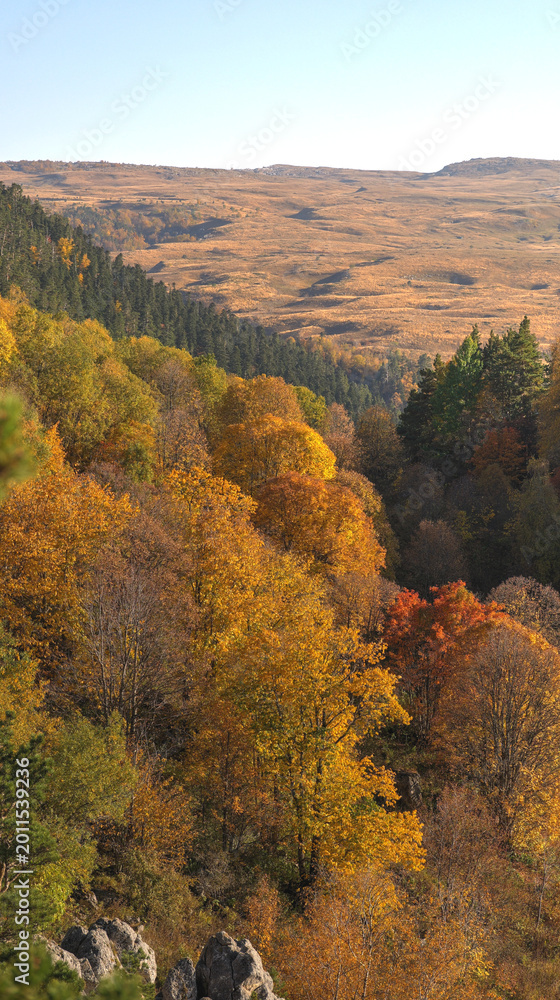 Fototapeta premium The photo shows a beautiful autumn landscape of the Caucasus Mountains