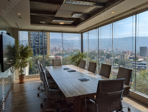 Interior of a contemporary executive conference room in a high-rise office featuring a long wooden table, leather chairs, and floor-to-ceiling windows overlooking a sunny urban skyline and mountains