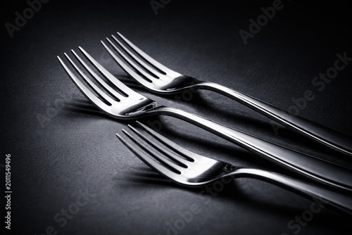 metallic forks with reflect...