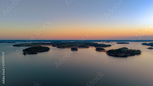 Photography Top-down aerial view of small boats at a wooden pier on the rocky coast of Turku