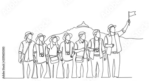 Tourists Group Following Leader with Flag on Mountain Background