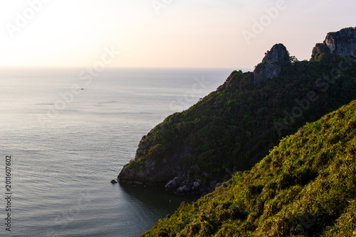 Konstfotografi Calm ocean water touching lush green mountain cliff in beautiful Thailand under