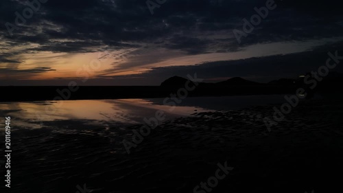 父母ヶ浜の夕暮れリフレクション ドローン空撮 香川・三豊市の絶景Drone aerial view of a stunning sunset reflection at Chichibugahama Beach in Mitoyo, Kagawa, Japan. The calm tidal flats create a mirror-like surface reflecting the col