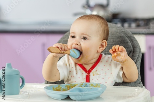 Photos Baby eating by herself at home