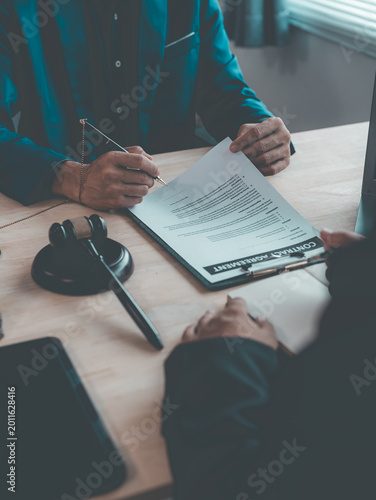 The judge's gavel on the table symbolizes legal agreement or the signing of a contract; a close-up image depicting business approval, contract signing, or agreement.