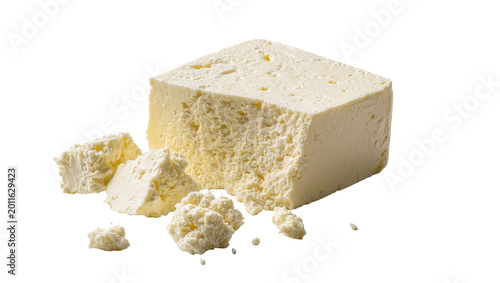 Foto Crumbled block of white feta cheese with porous texture, isolated on transparent