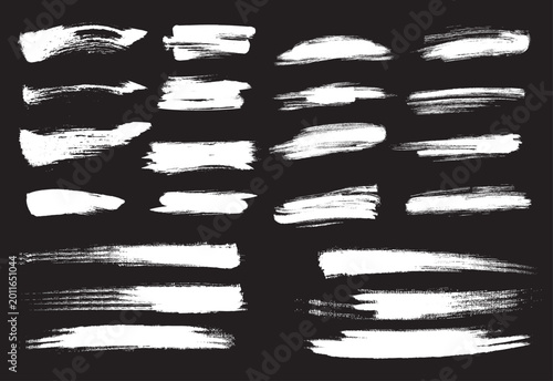 Multi dimension white paint brush collection isolated on dark background