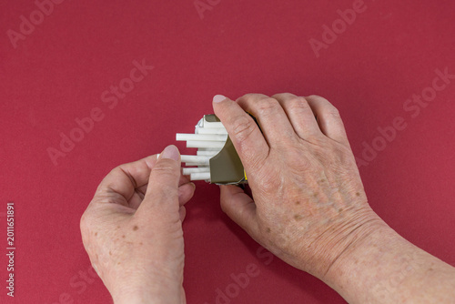 Senior woman is taking out a cigarette. Stop smoking in any age concept