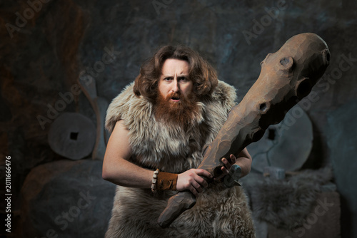 Surprised And Annoyed Caveman Holding Large Wooden Club – Prehistoric Portrait And Privacy Concept
