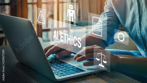 Person using laptop with digital icons representing AI ethics, including scales, warning signs, and robot symbols, in a modern workspace with wooden elements