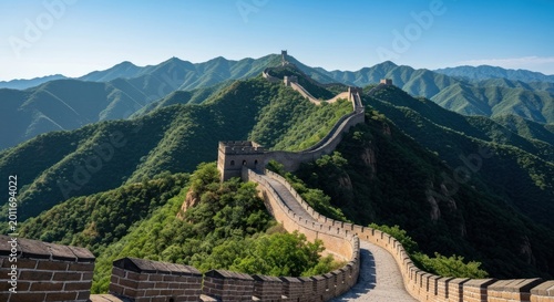 Ancient stone wall winds across lush mountain ranges under a clear sky