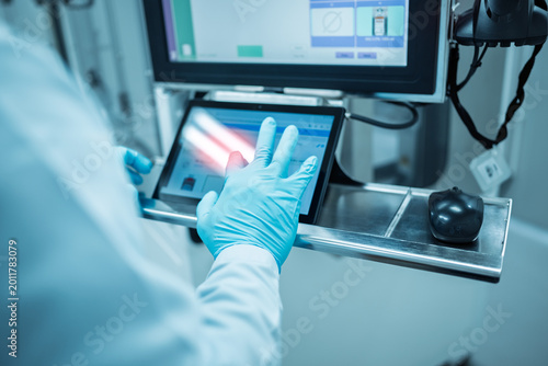 Man scientist using tablet computer in scientific office.Medical engineers work together on artificial intelligence data and analysis.Technician using computers production at electronics manufacture.