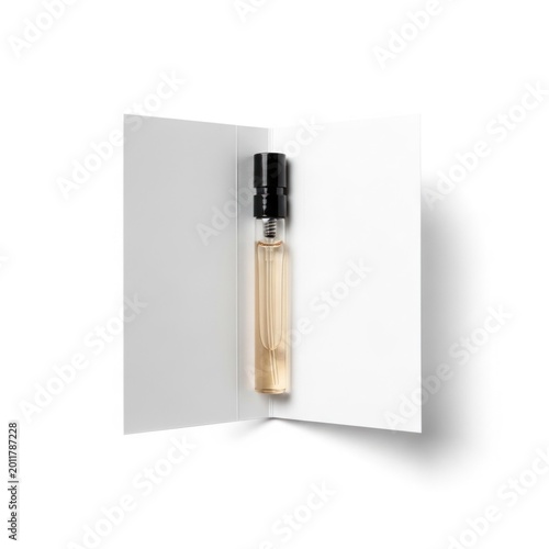Small glass bottle with liquid on a white card