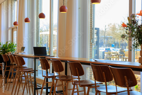 the modern cafeteria window seats with rows of tables